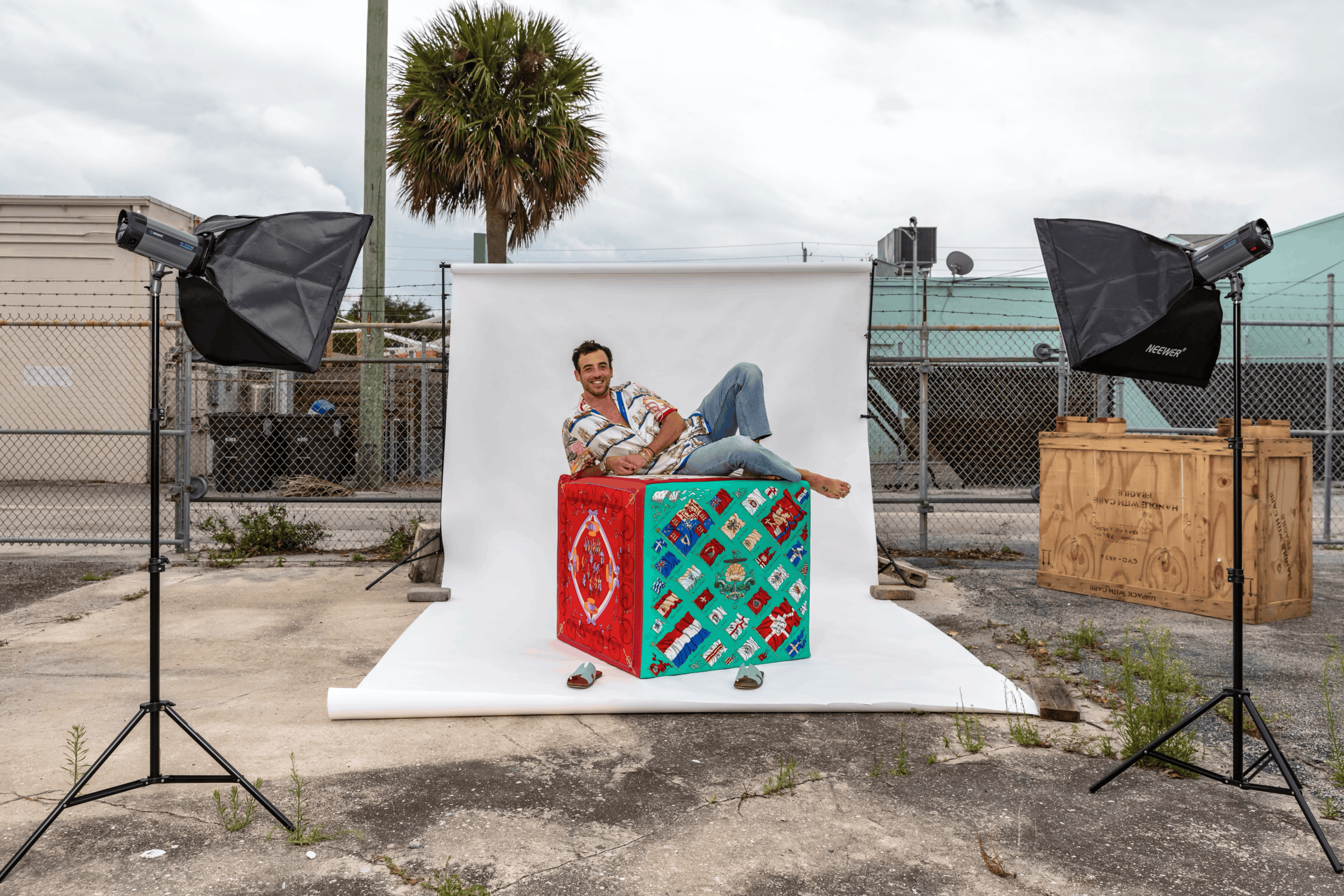 J. Logan Horne on an upholstered silk Block at an outdoor photo shoot in Palm Beach